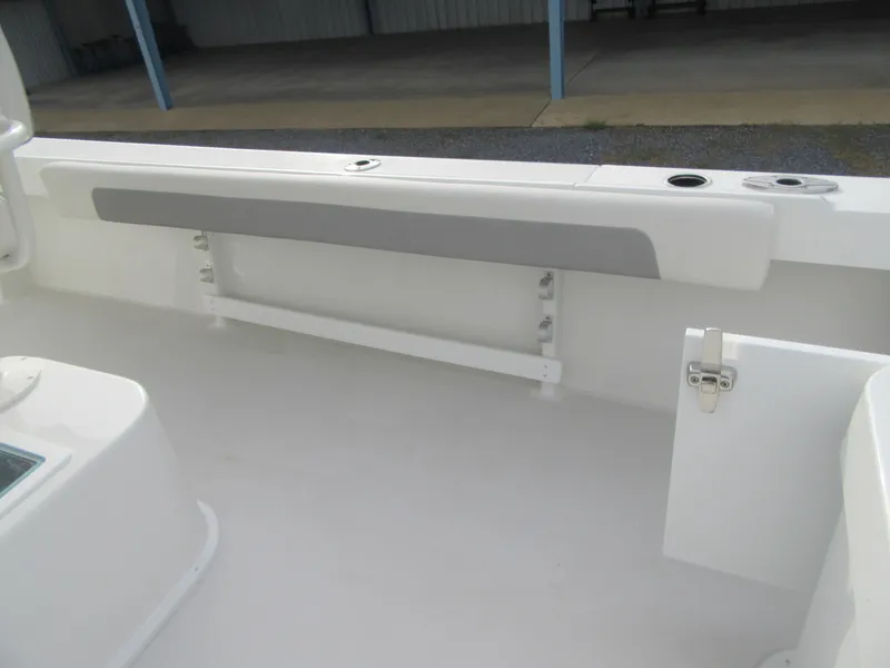 Slide: The Image of 2023 Parker 2501 Center Console boat interior with storage compartment and rod holders. - 21