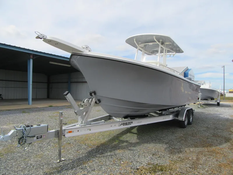Slide: The Image of 2023 Parker 2501 Center Console boat on a trailer in a storage area. - 3