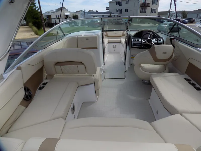 Slide: The Image of 2020 Regal 23 OBX boat interior with beige seating and modern dashboard. - 2