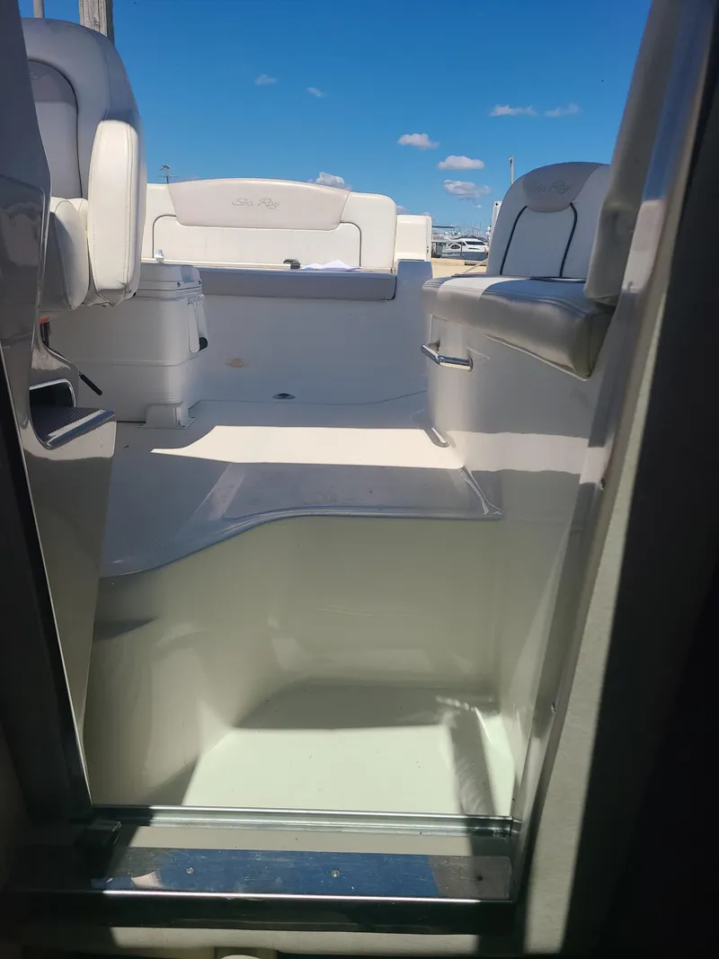 Slide: The Image of Interior view of 2010 Sea Ray 240 Sundancer boat under clear blue sky. - 14