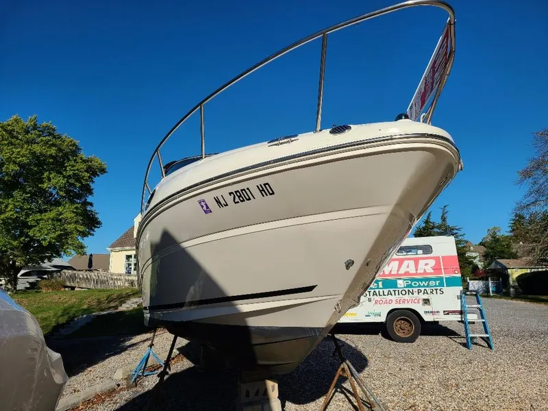 Slide: The Image of 2010 Sea Ray 240 Sundancer boat on trailer, sunny day, residential background. - 4