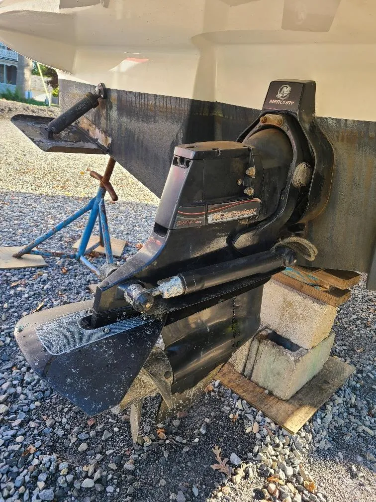 Slide: The Image of 2010 Sea Ray 240 Sundancer boat with MerCruiser outdrive on gravel. - 9