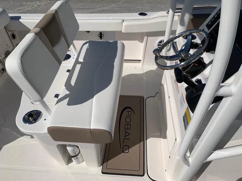 Slide: The Image of 2024 Robalo R222 Center Console boat interior with steering wheel and seating. - 12