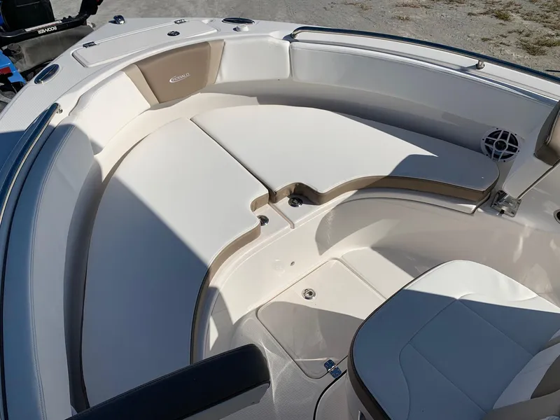 Slide: The Image of 2024 Robalo R222 Center Console boat interior with cushioned seating and storage. - 17