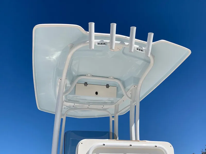 Slide: The Image of 2024 Robalo R222 Center Console boat T-top against clear blue sky. - 4