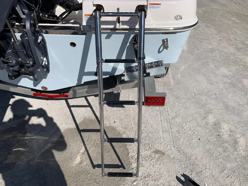 Slide: The Image of 2024 Robalo R222 Center Console boat with extended swim ladder. - 5