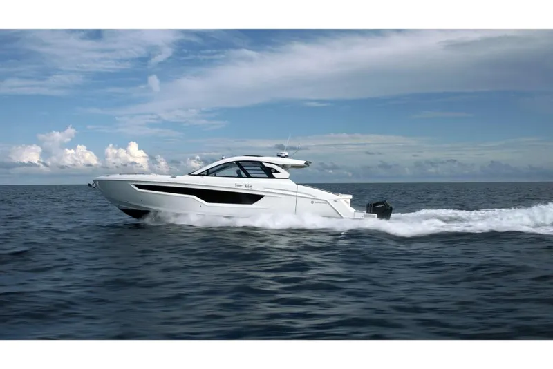 Slide: The Image of 2023 Cruisers Yachts 50 GLS luxury boat cruising on open water. - 2