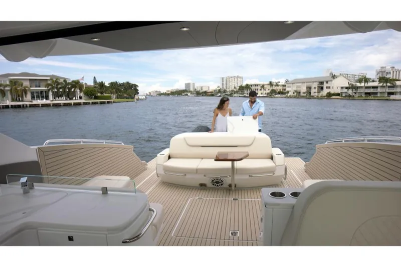 Slide: The Image of 2023 Cruisers Yachts 50 GLS luxury yacht on the water with two people onboard. - 5