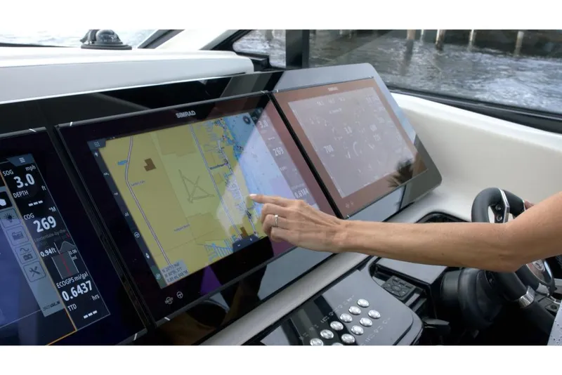 Slide: The Image of 2023 Cruisers Yachts 50 GLS touchscreen navigation system in use. - 7