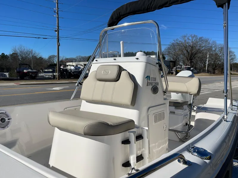 Slide: The Image of 2023 Key West 1720 Center Console boat with beige seating and steering console. - 12