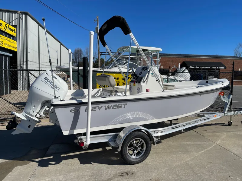 Slide: The Image of 2023 Key West 1720 Center Console boat on trailer, featuring Suzuki outboard motor. - 2