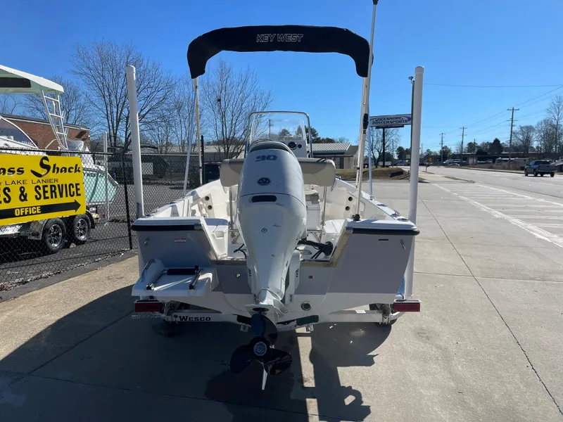 Slide: The Image of 2023 Key West 1720 Center Console boat with outboard motor, parked on a sunny day. - 5