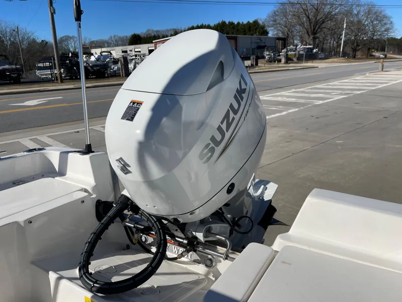 Slide: The Image of 2023 Key West 1720 Center Console with Suzuki outboard motor in a parking lot. - 8