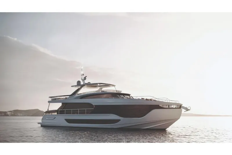 Slide: The Image of 2023 Azimut Grande 26M luxury yacht on calm waters at sunset. - 2