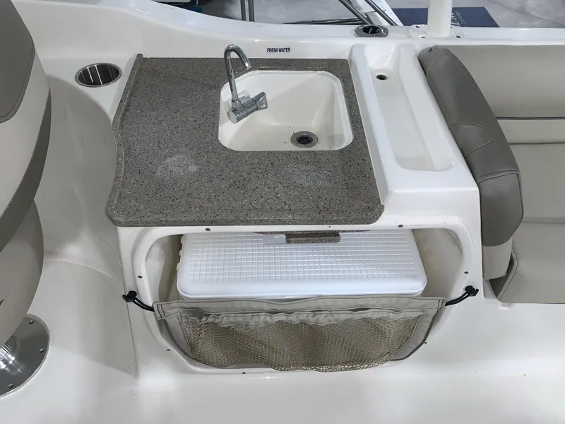 Slide: The Image of 2024 Key West 239 DFS boat interior with sink and storage compartment. - 11