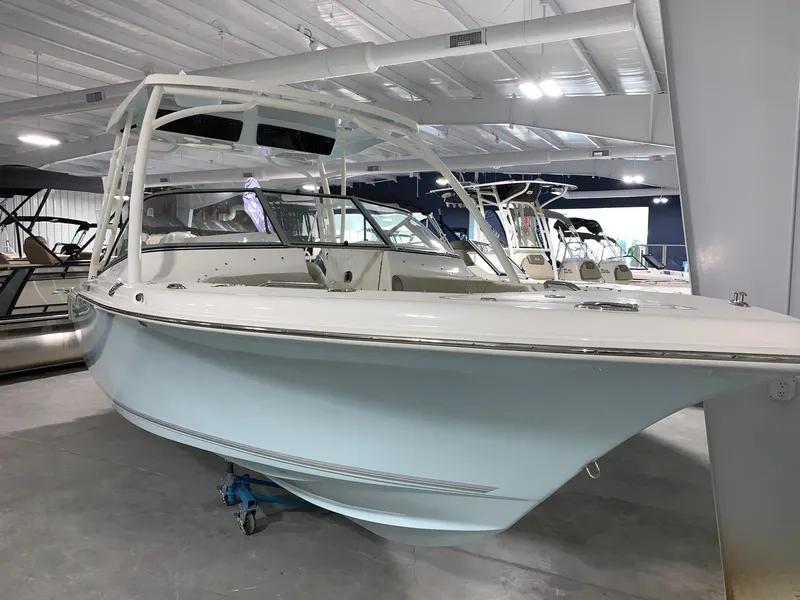 Slide: The Image of 2024 Key West 239 DFS boat displayed in a showroom. - 2