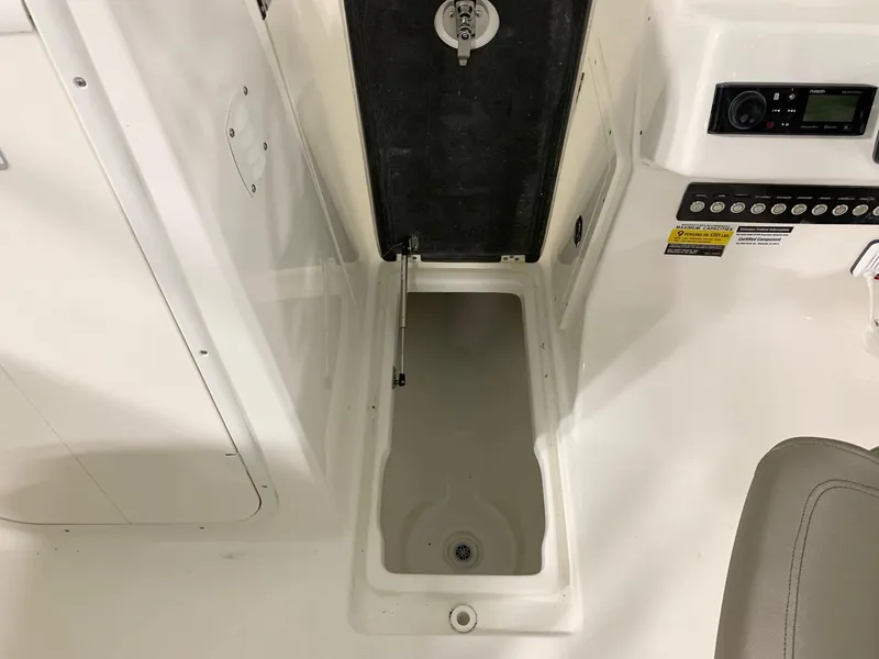 Slide: The Image of 2024 Key West 239 DFS boat interior storage compartment and control panel. - 6