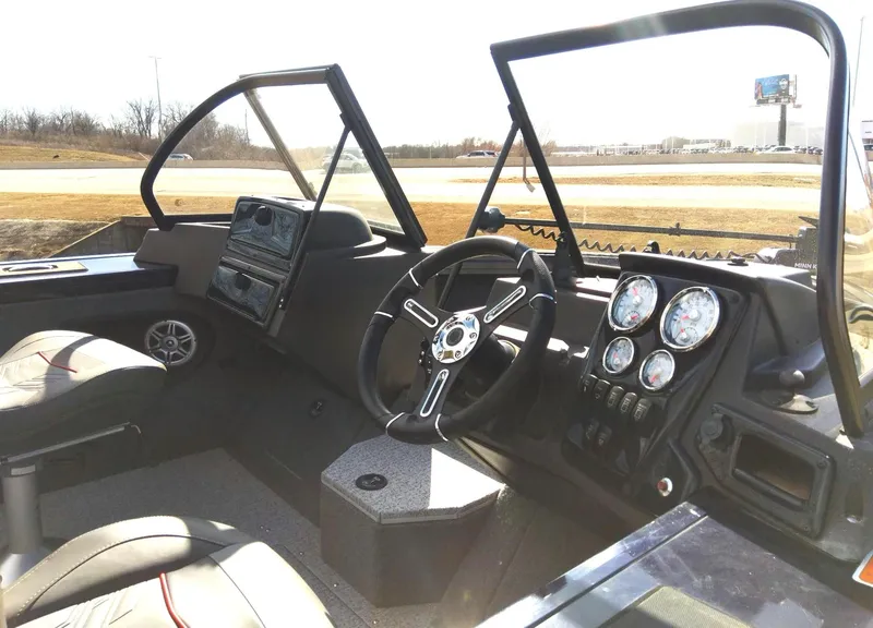 Slide: The Image of 2023 Tracker Targa V-18 WT boat interior with steering wheel and dashboard. - 5