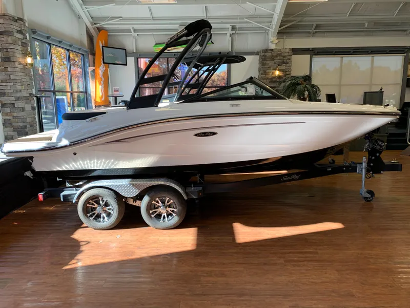 The Image of 2023 Sea Ray SPX 190 boat on display in a showroom. - 1