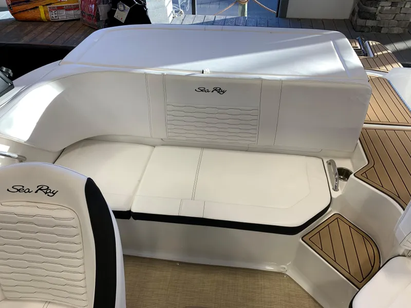 Slide: The Image of 2023 Sea Ray SPX 190 boat interior with white seating and teak flooring. - 4