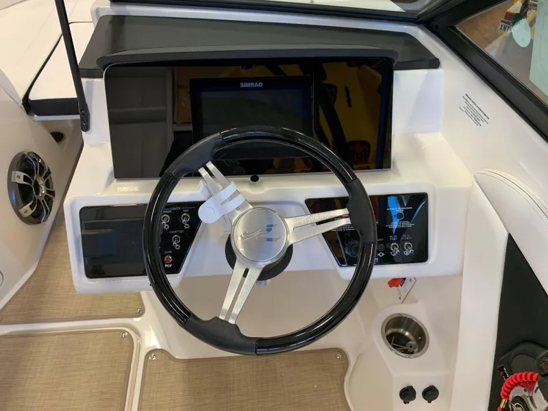 Slide: The Image of 2023 Sea Ray SPX 190 boat dashboard with steering wheel and control panel. - 6