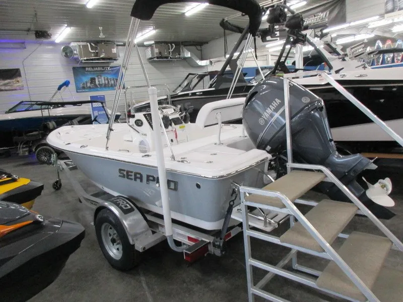 Slide: The Image of 2023 Sea Pro 172 Bay Series boat on trailer in showroom with Yamaha outboard motor. - 11