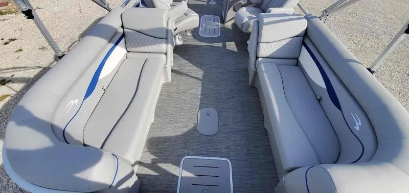 Slide: The Image of 2023 Bennington 22SVSR pontoon boat interior with gray seating and blue accents. - 10