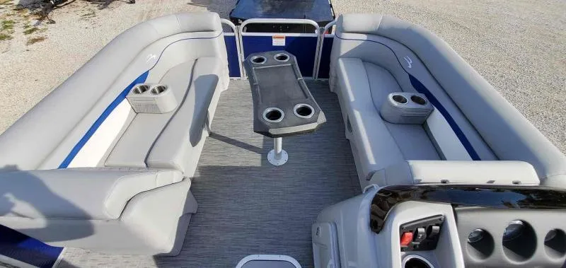 Slide: The Image of 2023 Bennington 22SVSR pontoon boat interior with gray seating and cup holders. - 2