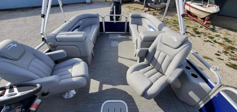 Slide: The Image of 2023 Bennington 22SVSR pontoon boat interior with plush gray seating and modern design. - 6