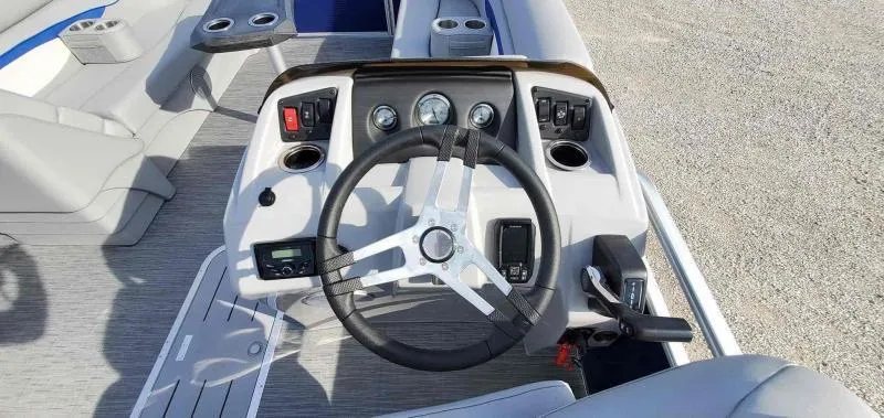 Slide: The Image of 2023 Bennington 22SVSR boat dashboard with steering wheel and controls. - 7