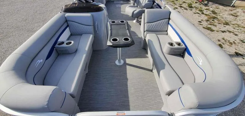 Slide: The Image of 2023 Bennington 22SVSR pontoon boat interior with gray seating and cup holders. - 8