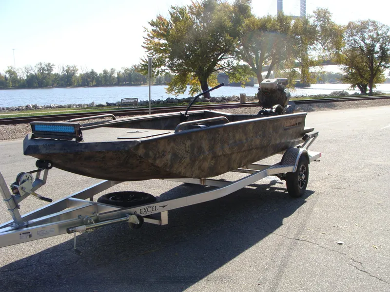 Slide: The Image of 2023 Excel 1754 Pro F4 boat on trailer by a lake. - 10
