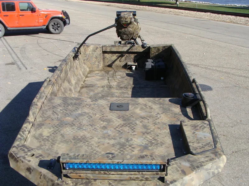 Slide: The Image of 2023 Excel 1754 Pro F4 boat with camouflage design on a trailer. - 4