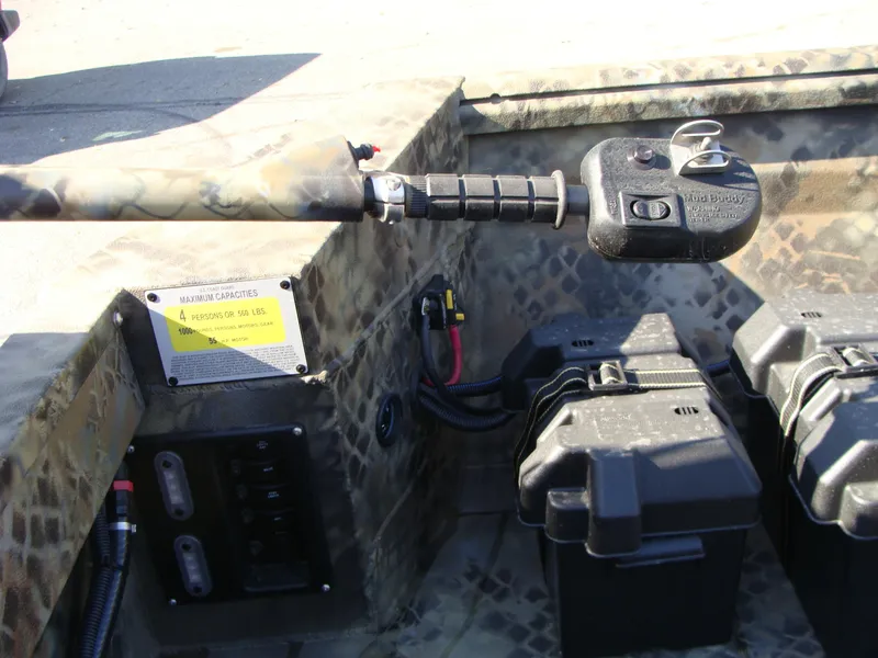 Slide: The Image of 2023 Excel 1754 Pro F4 boat interior with control panel and battery boxes. - 5