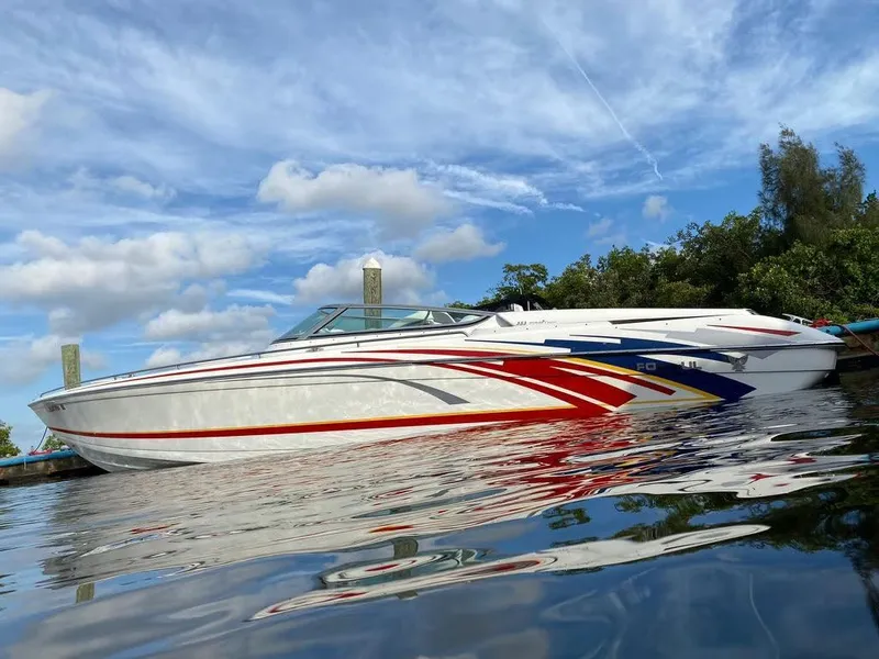Slide: The Image of 2007 Formula 353 FASTech speedboat on calm water with vibrant graphics. - 10