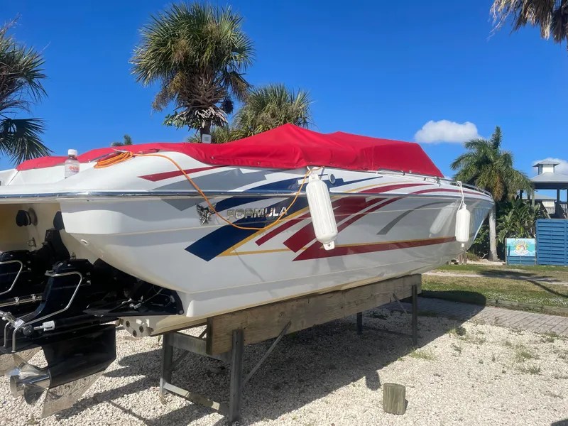 Slide: The Image of 2007 Formula 353 FASTech speedboat with red cover on dry dock. - 18