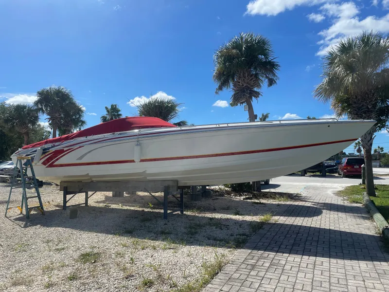 Slide: The Image of 2007 Formula 353 FASTech boat on a stand, with palm trees and blue sky background. - 19
