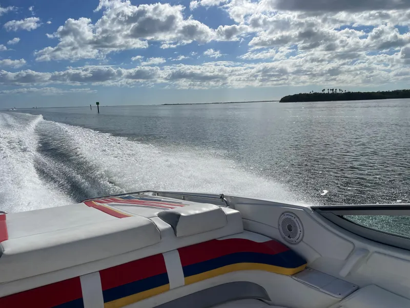 Slide: The Image of 2007 Formula 353 FASTech speedboat cruising on a sunny day with scenic water view. - 20