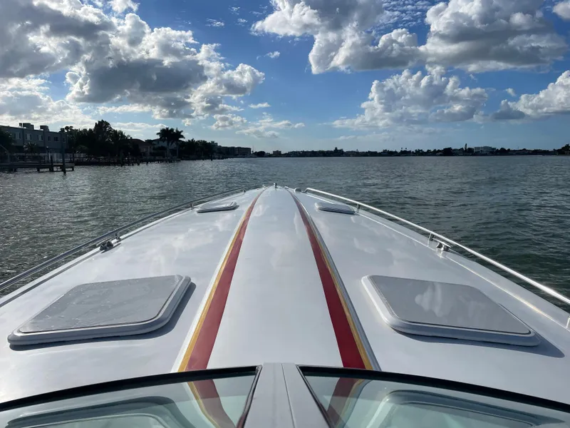 Slide: The Image of 2007 Formula 353 FASTech boat cruising on a sunny day with a scenic waterfront view. - 21