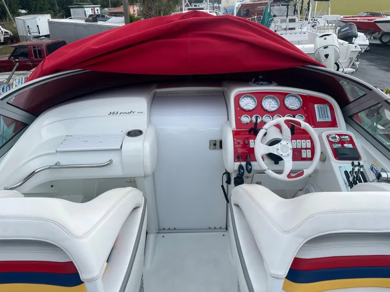 Slide: The Image of 2007 Formula 353 FASTech boat cockpit with red dashboard and white seating. - 24