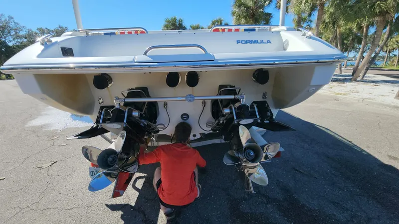 Slide: The Image of 2007 Formula 353 FASTech boat being serviced at the rear with dual propellers. - 3