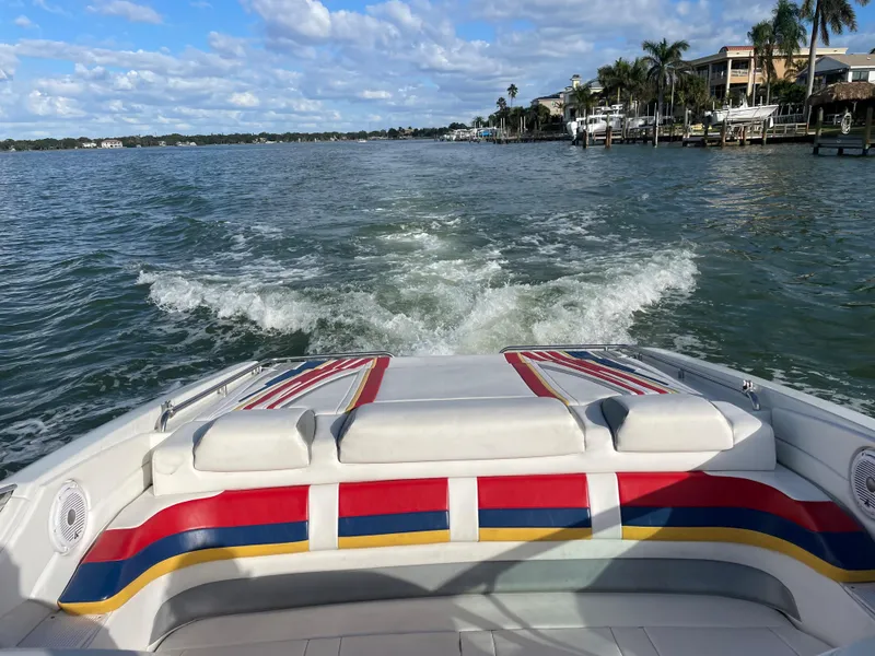 Slide: The Image of 2007 Formula 353 FASTech boat cruising on a scenic waterway with colorful seating. - 33
