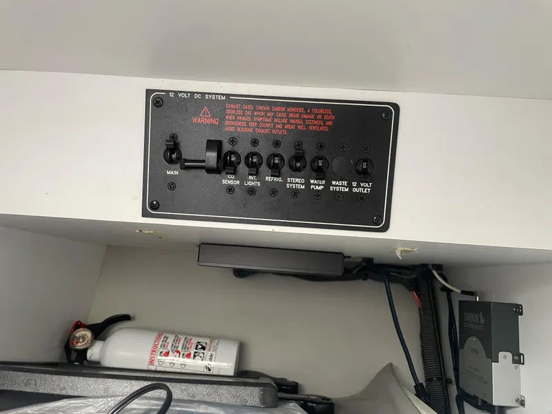 Slide: The Image of Control panel of a 2007 Formula 353 FASTech boat with switches and fire extinguisher. - 44