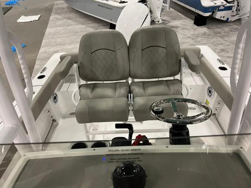 Slide: The Image of 2023 Sportsman 211 Heritage boat interior with dual seats and steering wheel. - 10