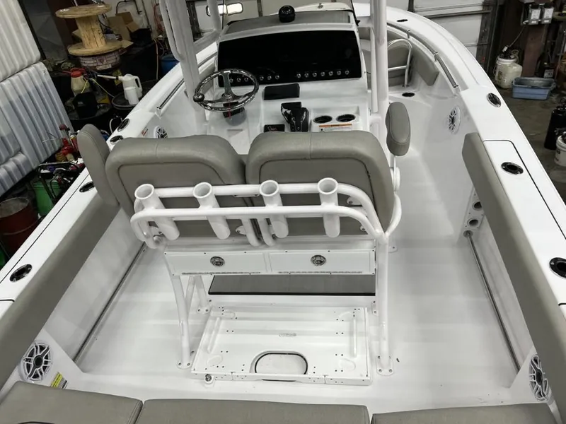 Slide: The Image of 2023 Sportsman 211 Heritage boat interior with dual seats and fishing rod holders. - 11