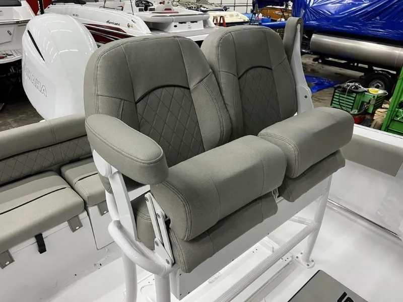 Slide: The Image of 2023 Sportsman 211 Heritage boat with comfortable dual seating and Yamaha engine in showroom. - 12