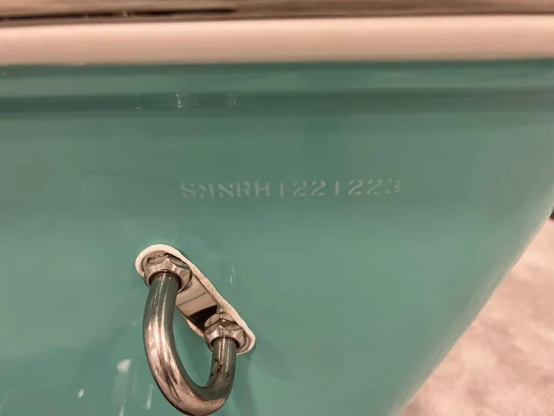 Slide: The Image of 2023 Sportsman 211 Heritage boat hull with serial number and metal cleat. - 23