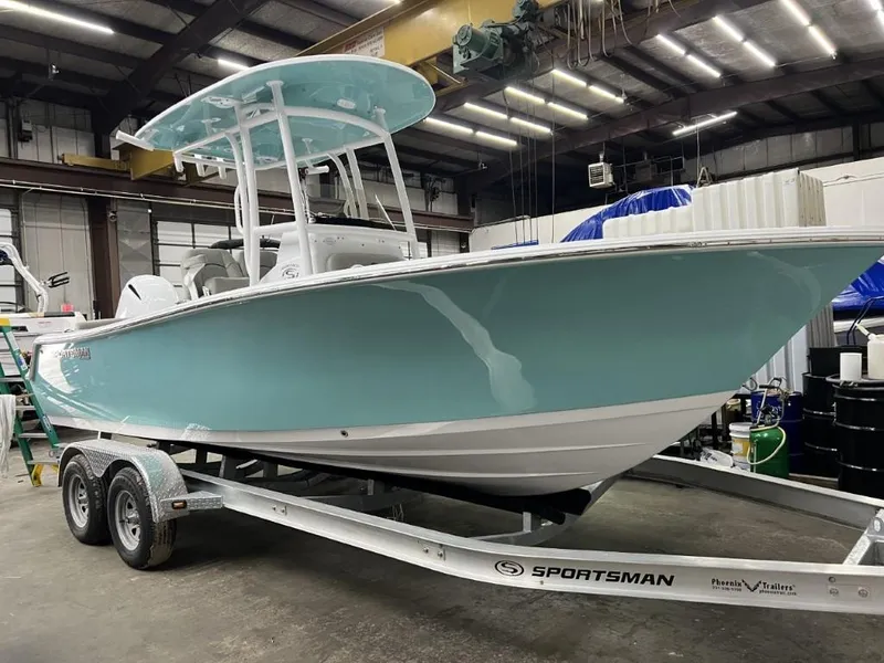 Slide: The Image of 2023 Sportsman 211 Heritage boat on trailer in warehouse. - 3
