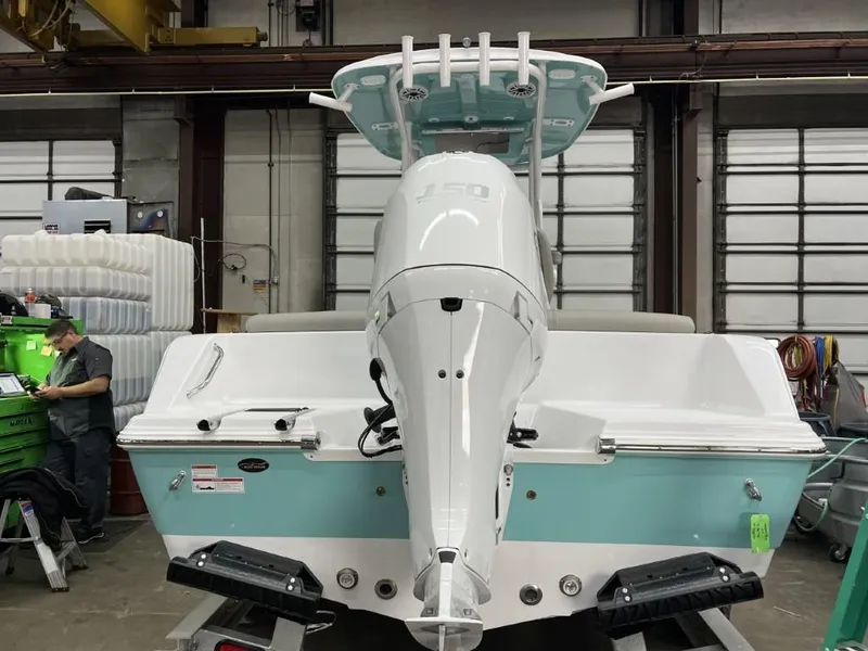 Slide: The Image of 2023 Sportsman 211 Heritage boat in a workshop, rear view with outboard motor. - 4