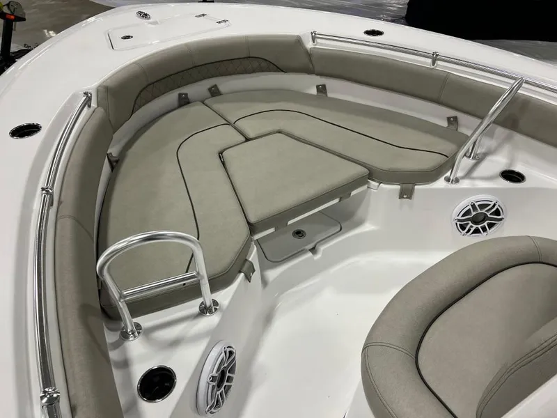 Slide: The Image of 2023 Sportsman 211 Heritage boat interior with cushioned seating and stainless steel railings. - 6
